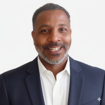Robert wearing a dark sport jacket and white shirt against a light gray background