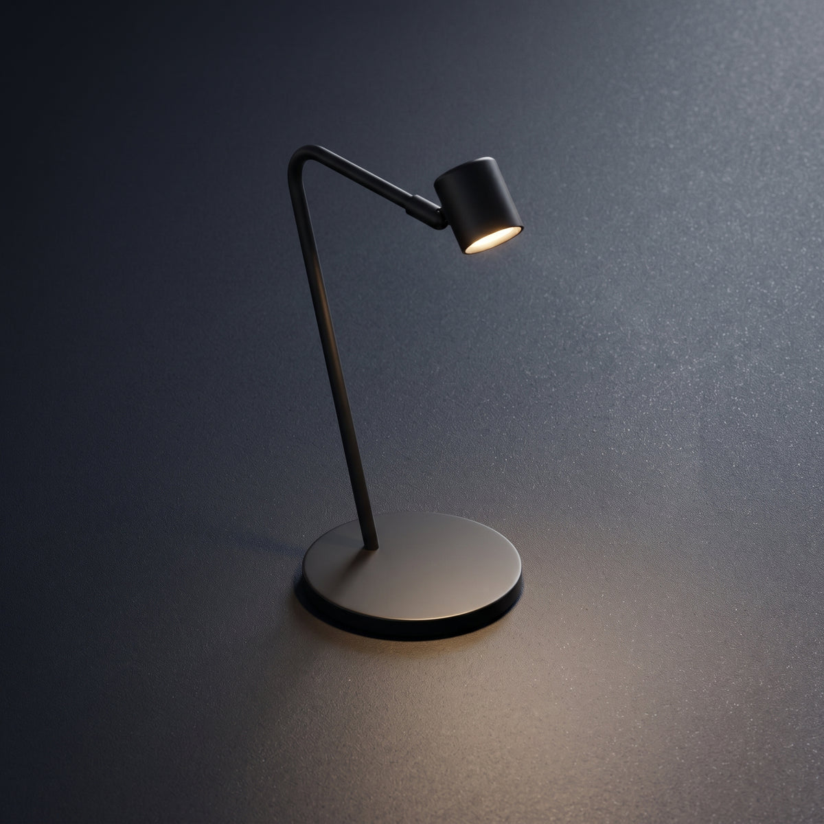 A modern black adjustable desk lamp with a circular base and curved arm, shown lit against a dark gray textured background.